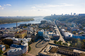 Fototapeta premium Aerial top view of Saint Andrew's church and Andreevska street from above, Podol district, city of Kyiv, Ukraine