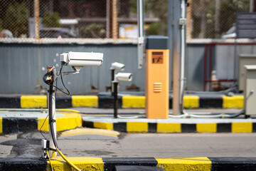 Security camera at entrance of car parking area, using to monitoring and recording for safety reason. Selective focus on the object.