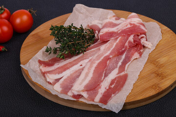 Raw bacon on the board