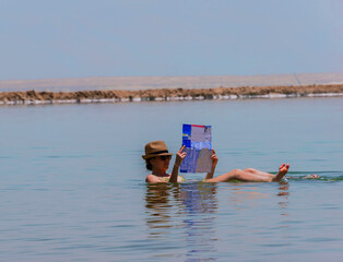 Woman floating in the dead sea