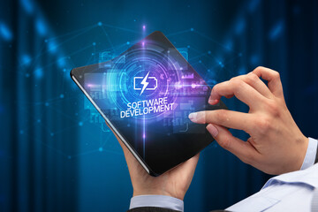 Businessman holding a foldable smartphone with DATA SCIENCE inscription, new technology concept SOFTWARE DEVELOPMENT