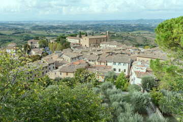 Fototapeta premium aerial cityscape with S.Agostino church and old roofs, San Gimignano, Siena, Italy