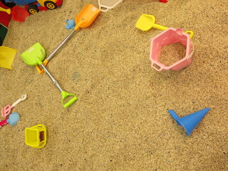 Fototapeta na wymiar toys and tools in the children's sandpit