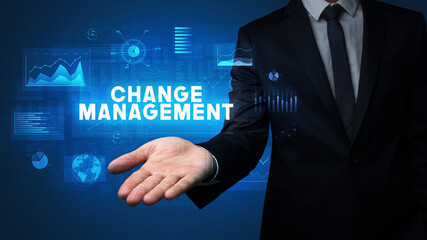 Hand of Businessman holding CHANGE MANAGEMENT inscription, business success concept