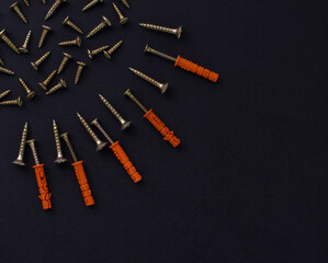 The abstract form and background for the text is made of screws and dowels on a black background (top view).