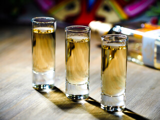 Three shots of tequila in tall shot glasses © Big City Lights