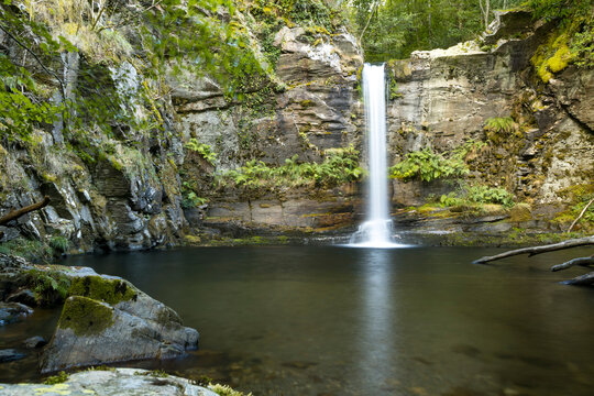 beautiful waterfall falling over a pool of crystal clear water in O Courel.