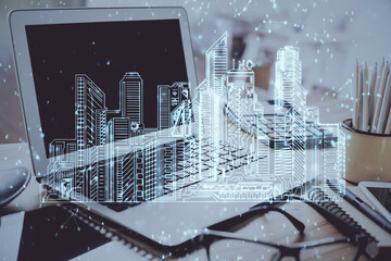 Desktop computer background in office and big town buildings hologram drawing. Double exposure. Smart city concept.