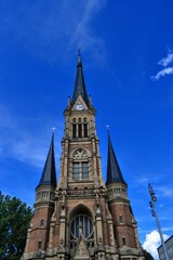 Fototapeta na wymiar Church, details of architecture and blue sky in Chemnitz. St. Peter's Church, Chemnitz (Petrikirche) Germany. During sunny day with blue sky.