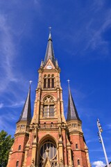 Fototapeta na wymiar Church, details of architecture and blue sky in Chemnitz. St. Peter's Church, Chemnitz (Petrikirche) Germany. During sunny day with blue sky.
