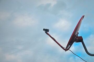 Satellite dish on blue sky background