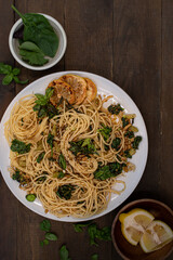 Vegan lemon and basil infused spaghetti dish on wooden table