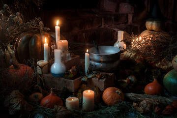 Obraz na płótnie Canvas candles, pumpkins, and a pot of witch potion on the fire. Halloween