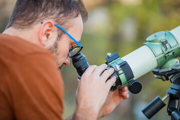 Amateur astronomer looking at the sky with a telescope.