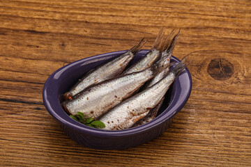 Anchovies in the bowl served basil leaves