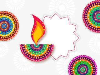 Creative Colorful Lit Oil Lamp (Diya) With Mandala Patterns And Empty Frame On White Background.