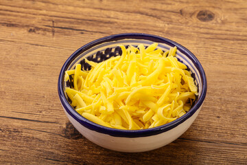 Shredded yellow cheese in the bowl