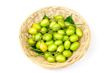Fresh Neem fruit on Wicker basket isolated on white background.