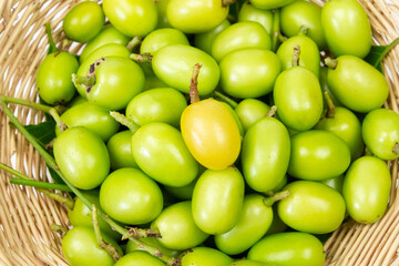 Fresh Neem fruit on Wicker basket, top view. 