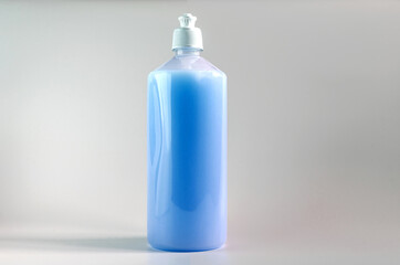 plastic bottle with liquid soap in blue on a white background