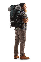 Full length shot of a young bearded man with a backpack and hiking equipment