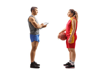 Full length profile shot of a basketball coach talking to a female player