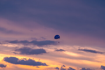 Parasailing on sunset and blue sky background in tropical country