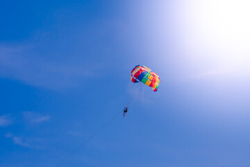 Parasailing in blue sky. Sports, active leisure, travel, vacation concept
