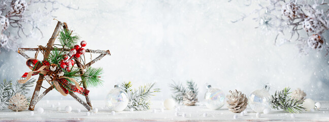 Christmas still life with decorated wooden Christmas Star on light background. Winter festive concept.