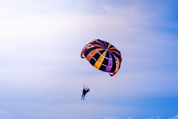 Parasailing in blue sky. Sports, active leisure, travel, vacation concept