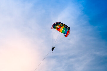 Parasailing in blue sky. Sports, active leisure, travel, vacation concept
