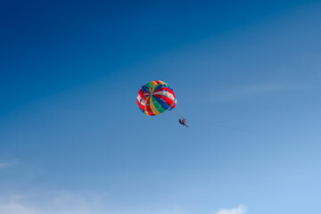 Parasailing in blue sky. Sports, active leisure, travel, vacation concept