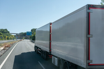 Road train or mega truck, truck with two semi trailers circulating on the highway.