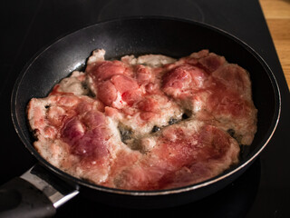 Pork steaks in frying pan with onion