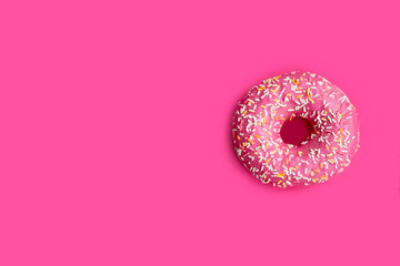 pink donut isolated on pink background. Harmful and correct food. Healthy lifestyle. Choice in...