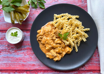 Classic chicken goulash with fusilli pasta in sour creme gravy and served with gherkins. 
