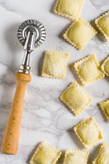 Ravioli, and a pastry cutter wheel on the table. Top View