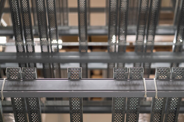 Structure beam's part of products racking shelves in factory storage warehouse. Close-up and selective focus at some part of the metal-end structure.