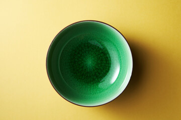 green bowl on yellow background