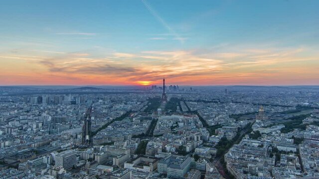 Panorama of Paris at sunset timelapse. Eiffel tower view from observation deck of montparnasse building in Paris - France. Colorful sky at summer day