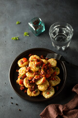 Homemade gnocchi with fried sausage and tomato