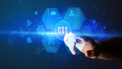 Hand touching CSS inscription, new technology concept