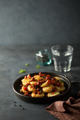 Homemade gnocchi with fried sausage and tomato