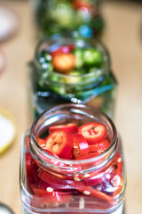 Colourful jalapenos pepper cuts in glasses prepared for preservation/fermentation