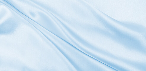 Smooth elegant blue silk or satin luxury cloth texture as abstract background. Luxurious background...