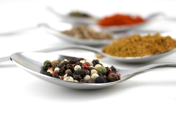 Colourful various herbs and spices for cooking on white background