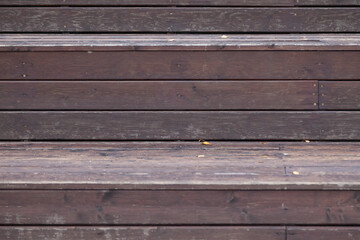 Wooden slats knocked tightly to each other in brown and gray color background for decorative pano or autumn composition. Eco materials for construction and decoration.