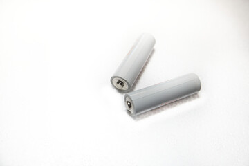 Two white batteries on white background