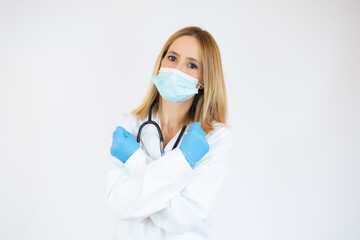 Beautiful female doctor or nurse wearing protective mask and latex or rubber gloves on white background with copy space. Health care concept