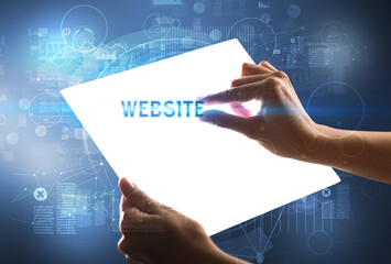 Hand holdig futuristic tablet with WEBSITE inscription, new technology concept